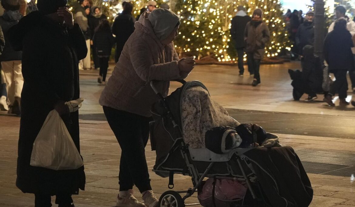 Paris City Hall plaza draws holiday visitors and migrant families seeking shelter as Olympics nears